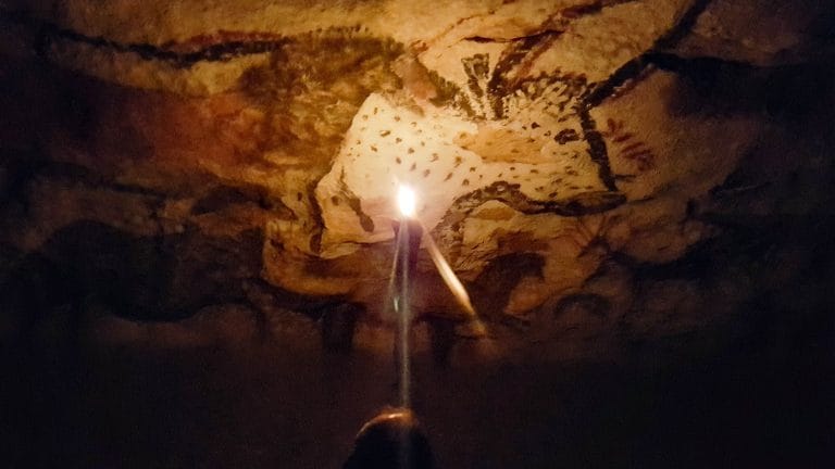 The famous Hall of Bulls in Lascaux 2 lit up by a candle.