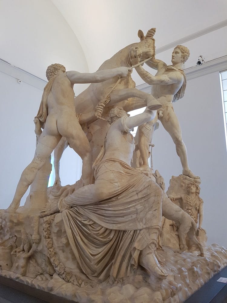 A closeup of the Farnese Bull showing Amphion and Zethus grappling with the bull to which they tie Dirce.