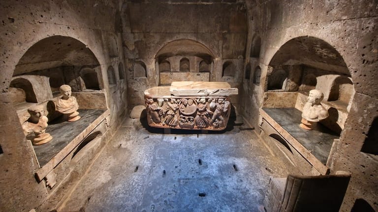 The interior of the Roman tomb at Weiden, with a beautifully carved sarcophagus in the centre.